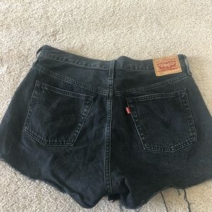 501 Levi black distressed jean shorts